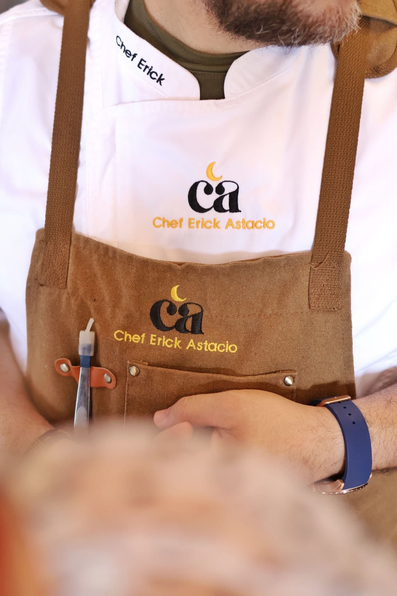 Chef Erick Astacio branded chef jacket and apron.